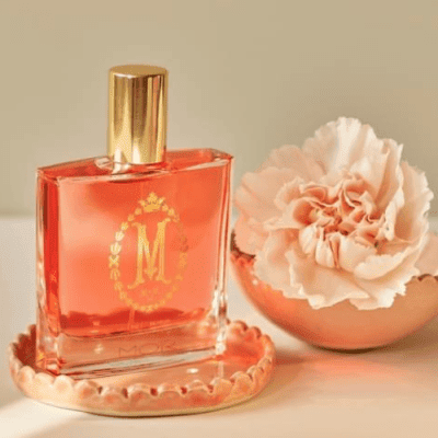 MOR marshmallow perfume in a tray with a carnation next to it