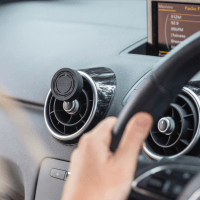 ECOYA car diffuser black case shown in the car aircon vents