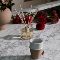 ECOYA diffuser on marble table with a cup of tea