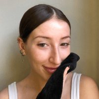 Model using the makeup mini black eraser on her face