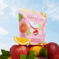 The makeup eraser healthy habit pack sitting on apples and oranges. Showing healthy food
