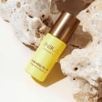 INIKA Organic Kakadu Plum Vitamin C Booster laying on rocks