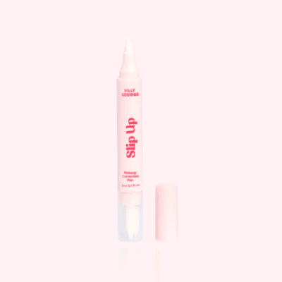 Silly George Slip Up Makeup Correction Pen with lid off on a pink backgroud
